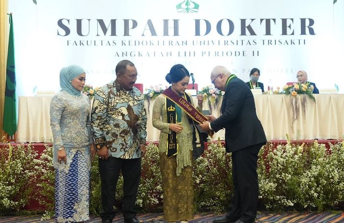 Penjabat (Pj) Bupati Bombana Burhanuddin saat mendampingi anaknya menjalani pengambilan sumpah dokter di Fakultas Kedokteran Trisakti. - Image