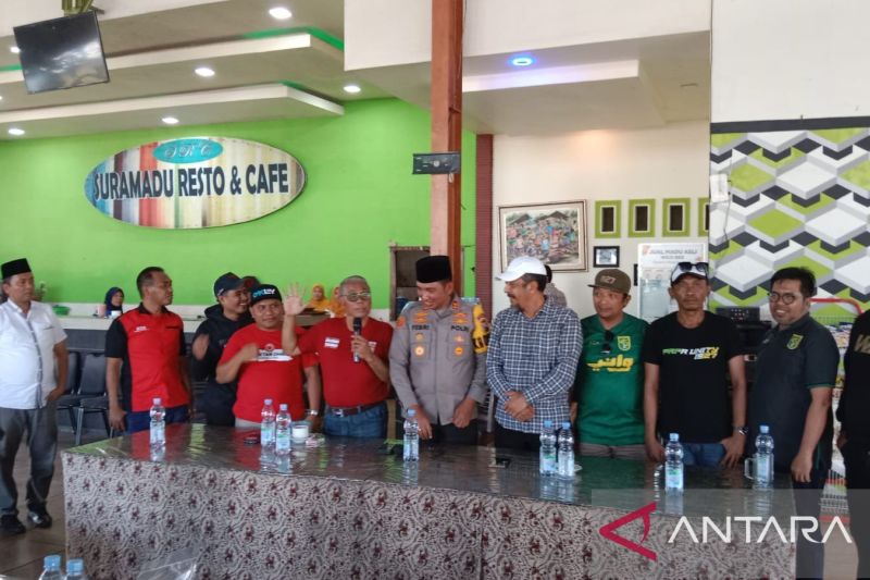Foto bersama antara petugas Polres Bangkalan dengan suporter Madura United FC dan Suporter Persebaya Surabaya. (ANTARA) - Image