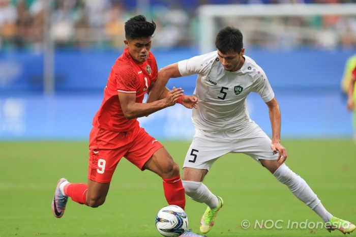 Ramadhan Sananta (kiri) berebut bola dengan bek Uzbekistan, Khamraliev Mukhammadkodir, di babak 16 besar Asian Games 2022. (NOC Indonesia/Naif Al - Image