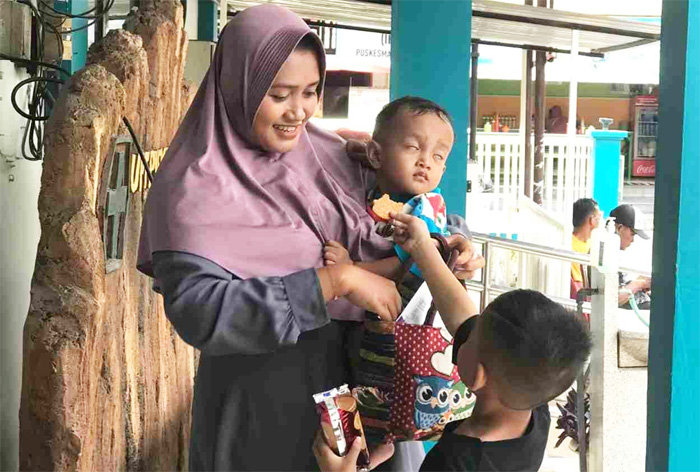 Novita Rahayu (26), seorang ibu muda asal Desa Yosowilangon, Kecamatan Manyar, Kabupaten GresiK bersyukur BPJS Kesehatan bisa memberikan layanan JKN untuk program kehamilan termasuk USG. - Image