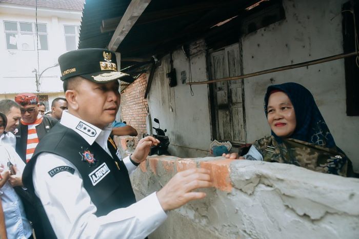 Pj Gubernur Sumsel Agus Fatoni menyerahkan bantuan rumah kepada masyarakat melalui program pemugaran RTLH di Lorong Lama, Kelurahan Bagus Kuning, Plaju, Palembang, Sumatera Selatan, Minggu (3/12). - Image