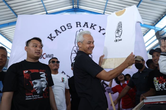 Calon presiden (capres) nomor urut 3, Ganjar Pranowo meluncurkan langsung sablon kaos gratis di Sekber Relawan Ganjar-Mahfud Jalan Adi Sucipto, Colomadu, Karanganyar, Jawa Tengah, Sabtu (30/12). - Image