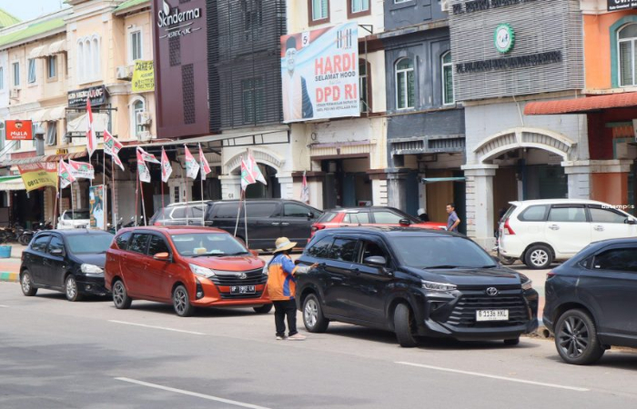 Juru parkir di kawasan Greendland Batamcenter mengatur pengendara yang akan keluar dari area parkir, Senin (15/1). - Image