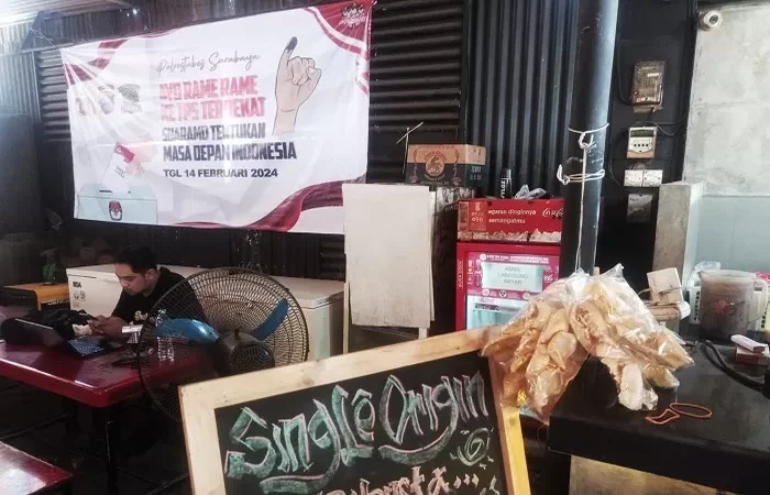 Spanduk sosialisasi tentang Pemilu 2024 terpasang di salah satu kedai kopi di kawasan Ngagel, Surabaya. (SURYANTO/RADAR SURABAYA) - Image