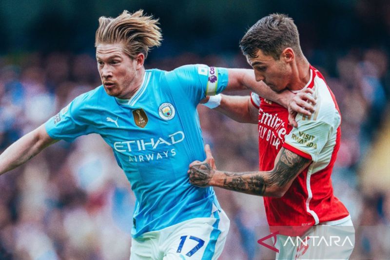 Manchester City, Kevin De Bruyne (kiri) berebut bola dengan Jakub Kiwior dari Arsenal pada Laga big match antara Manchester City kontra Arsenal berakhir imbang tanpa gol, Minggu (31/3). - Image