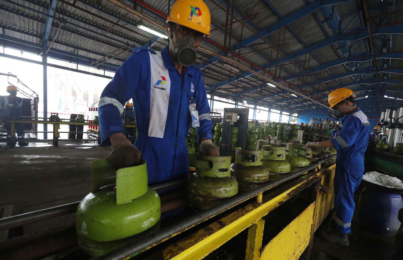 Sejumlah pekerja menyelesaikan pengisian gas elpiji 3 kg di Stasiun Pengisian Bahan Bakar Elpiji (SPBBE) Tanjung Priok, Jakarta. 