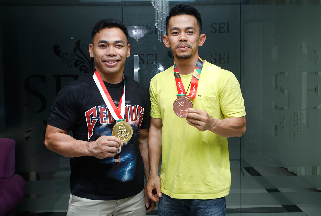 SALING MEMOTIVASI: Lifter Jatim Eko Yuli (kiri) dan Angga Romansah berhasil menyumbangkan medali buat daerahnya. (ANGGER BONDAN/JAWA POS) - Image