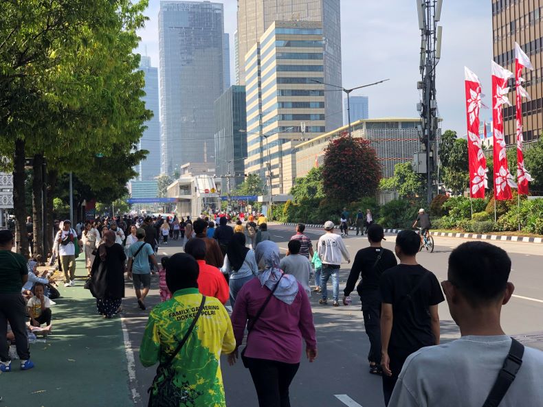 Sejumlah warga memadati Jalan MH Thamrin, Jakarta, menjelang pelantikan Presiden Prabowo Subianto. (Foto-foto: Syahrul Yunizar/JawaPos.com) - Image