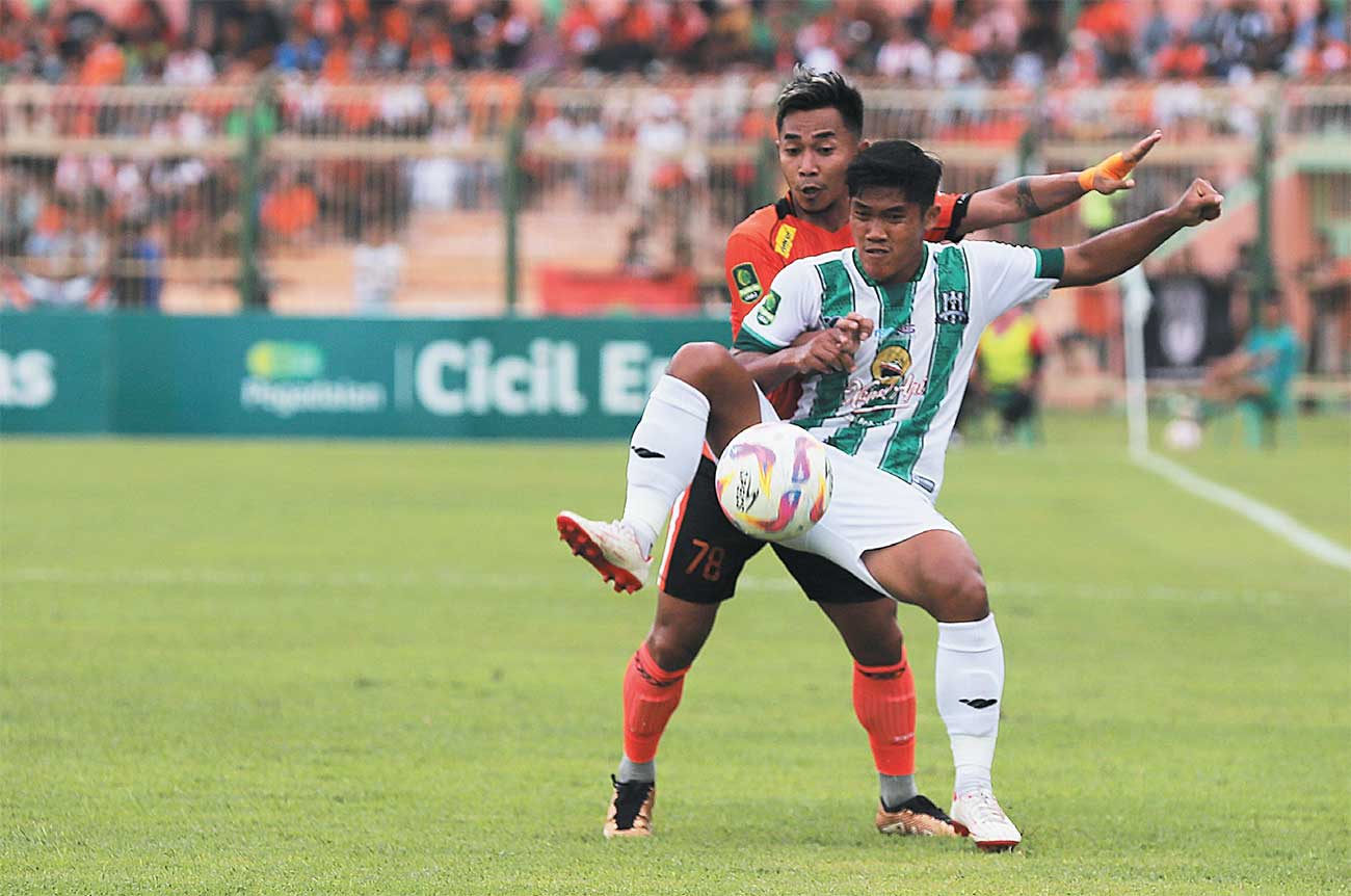 Penyerang Deltras FC Dwiki Mardiyanto mendapat pengawalan ketat dari Rahel Radiansyah di Stadion Letjen H Soedirman, Bojonegoro, kemarin. Berkali-kali Dwiki merepotkan barisan pertahanan tuan rumah. - Image