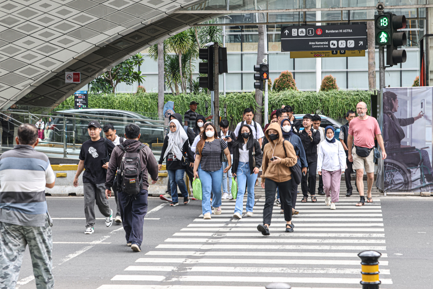 Sejumlah pekerja berjalan di sekitaran Bundaran HI, Jakarta, Rabu (08/01/2025). Pemerintah resmi menaikkan usia pensiun pekerja swasta dari 56 tahun menjadi 59 tahun lewat Pemerintah (PP) Nomor 45 Tahun 2015 tentang Penyelenggaraan Program Jaminan Pensiun - Image