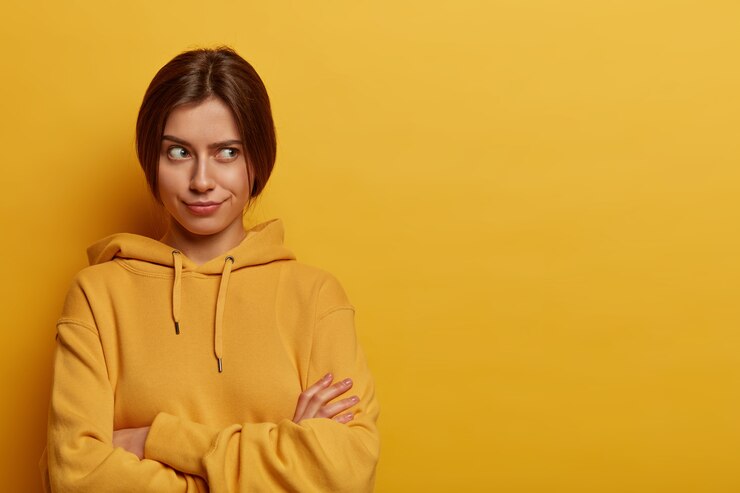 Ilustrasi seseorang memakai hoodie kuning. (wayhomestudio/freepik) - Image