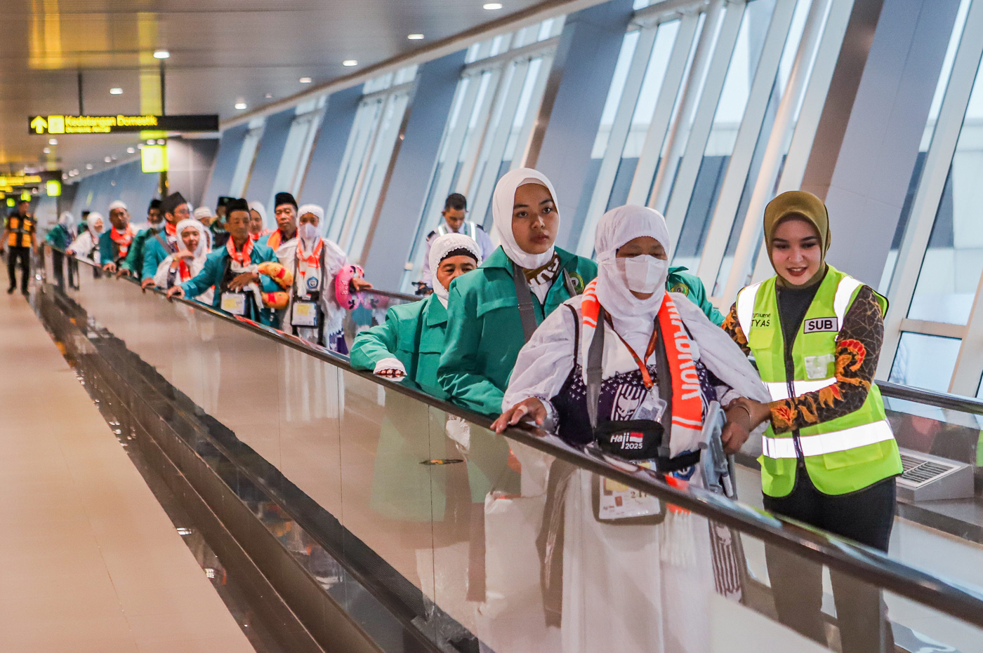 Jamaah calon haji menuju pesawat saat pemberangkatan di Terminal 1 Bandara Internasional Juanda, Jawa Timur, Jumat (2/5/2025). (Riana Setiawan/ Jawa Pos)