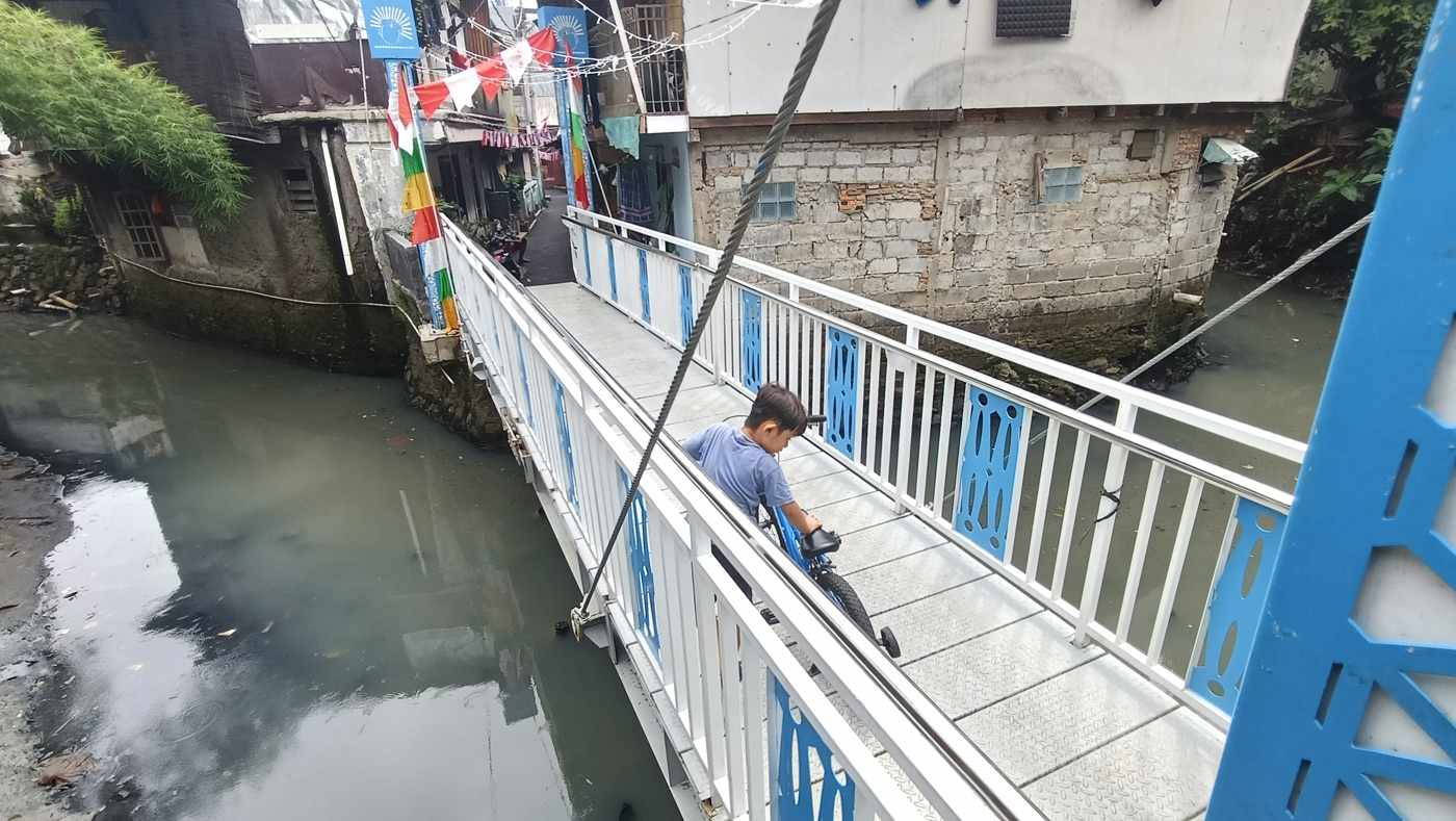 Anak kecil melintas di Jembatan Antar Kampung (JAK) Angkat Mulia, Gandaria, Jakarta, Selasa (19/8/20