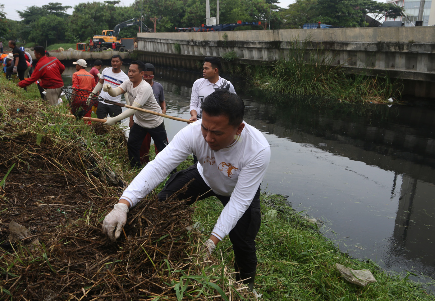Petugas kebersihan bersama warga bergotong royong membersihkan sungai dari sampah dan sedimentasi di