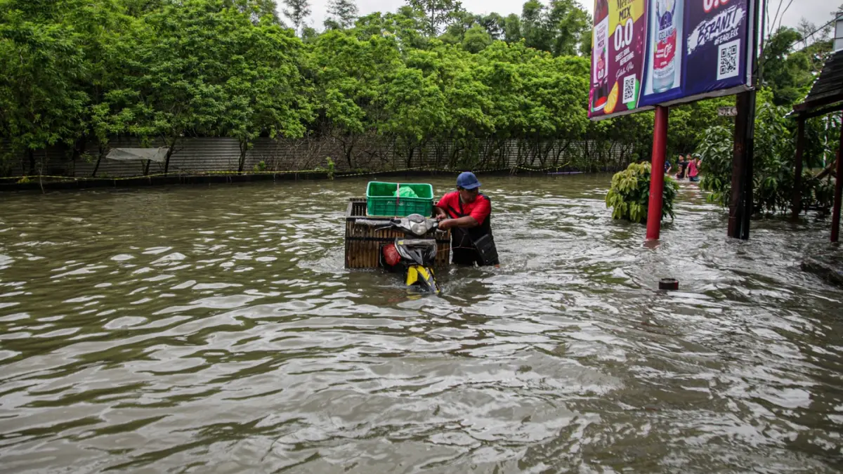Sejumlah pengendara terjebak banjir di perempatan jalan Kembangan, Jakarta, Minggu (8/3/2026). (Hanung Hambara/Jawa Pos)