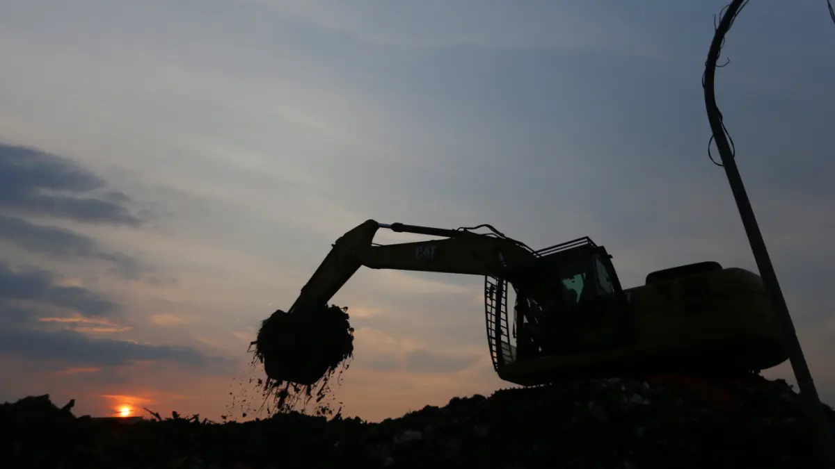 Alat berat melakukan pengangkutan gunungan sampah yang mengendap di Pasar Induk Kramat Jati, Jakarta Timur, Selasa (7/4/2026). (Dery Ridwansah/ JawaPos.com)