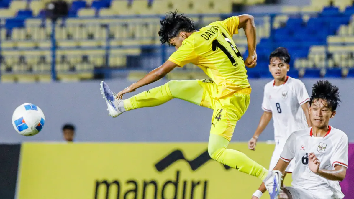 Pemain Timnas Indonesia U-17, Girly Guevara berusaha melewati hadangan pemain Malaysia U-17 Dawud Imran dalam ASEAN U-17 Boys Championship di Stadion Gelora Joko Samudro, Gresik, Kamis (16/4). (Riana Setiawan/ Jawa Pos)