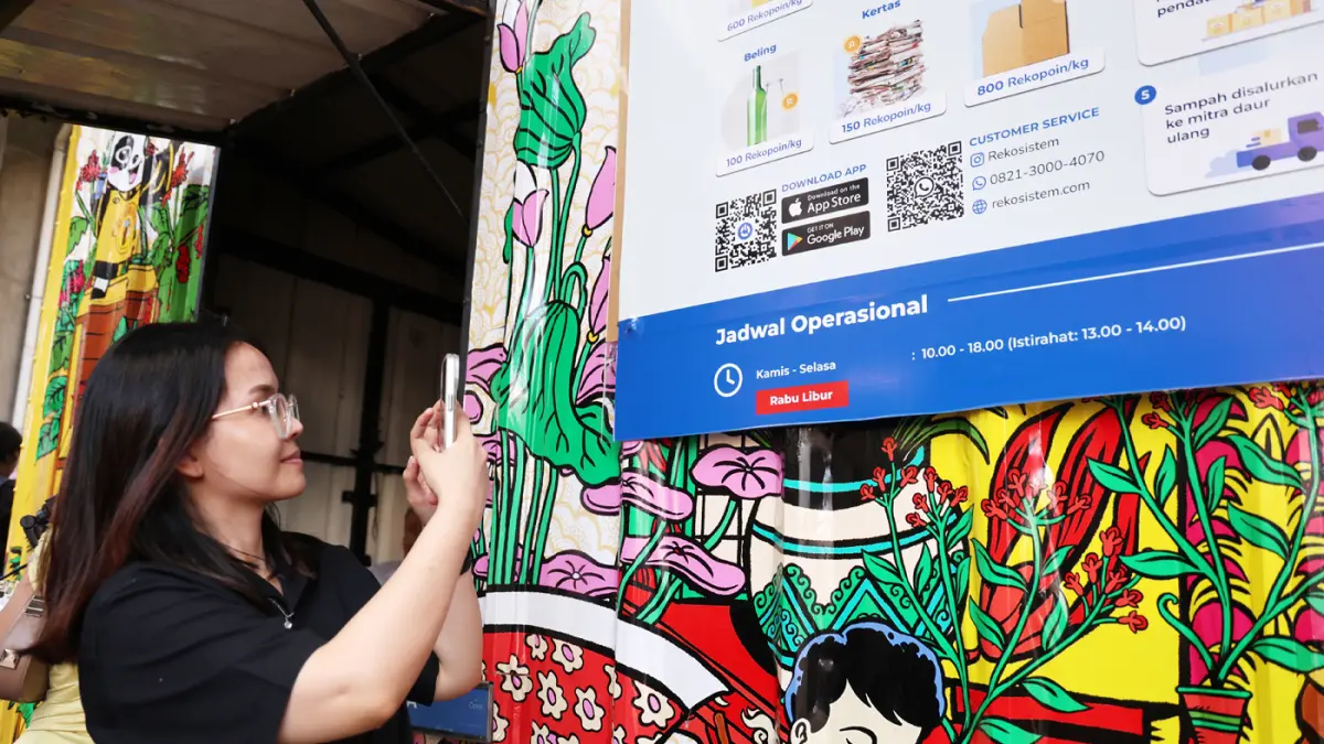 Pejalan kaki menyerahkan sampah di Waste Station di MRT Blok M Jakarta, Jumat (24/6/2026).