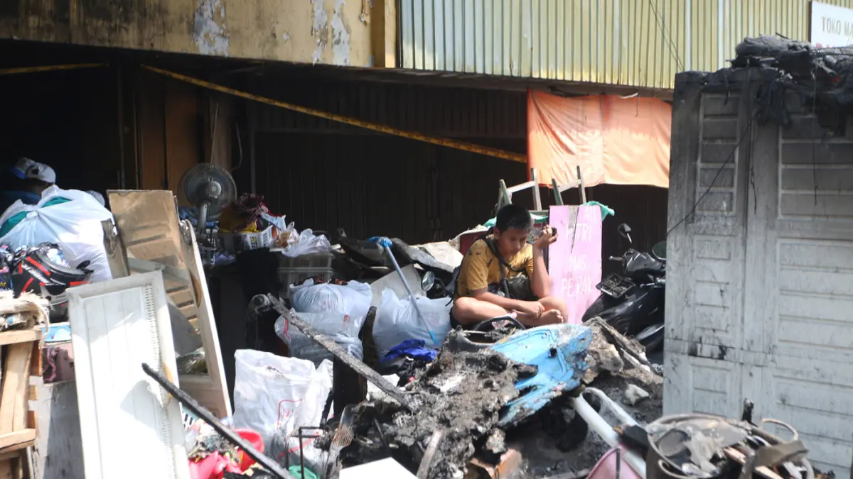 Pedagang tampak memilah sisa-sisa barang yang masih bisa diselamatkan seusai kebakaran melanda Pasar Kanjengan, Kecamatan Semarang Tengah, Kota Semarang, Kamis (30/4/2026). (Nur Chamim/Jawa Pos Radar Semarang)