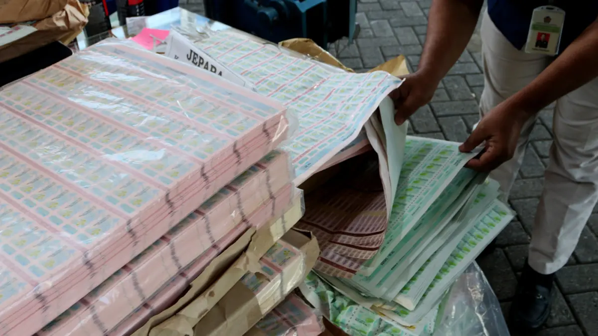 Petugas memeriksa sejumlah barang bukti hasil pengungkapan kasus percetakan pita cukai ilegal di Kota Semarang, Jawa Tengah, Rabu (20/5/2026). (Nur Chamim/Jawa Pos Radar Semarang)