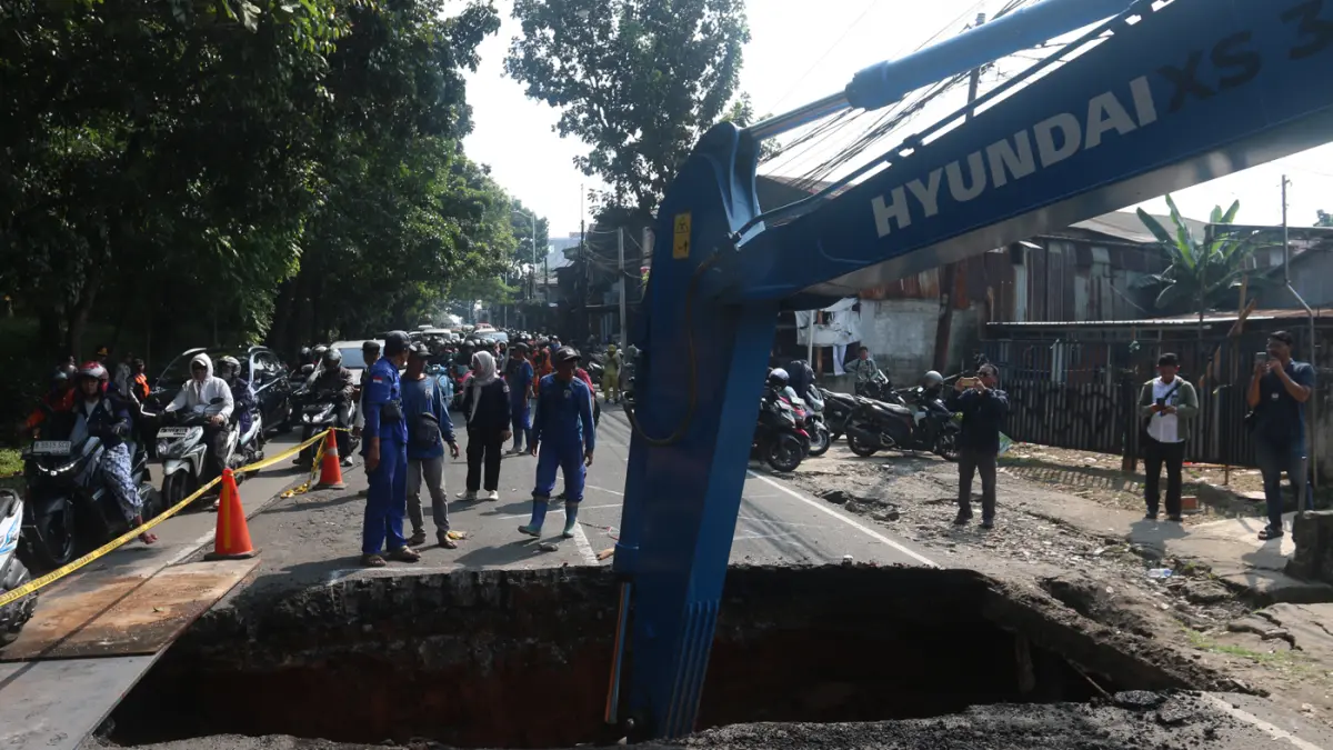 Petugas memperbaiki kondisi jalan yang amblas di Jalan Raya Lenteng Agung, Jakarta Selatan, Jumat (29/5/2026). (Dery Ridwansah/ JawaPos.com)
