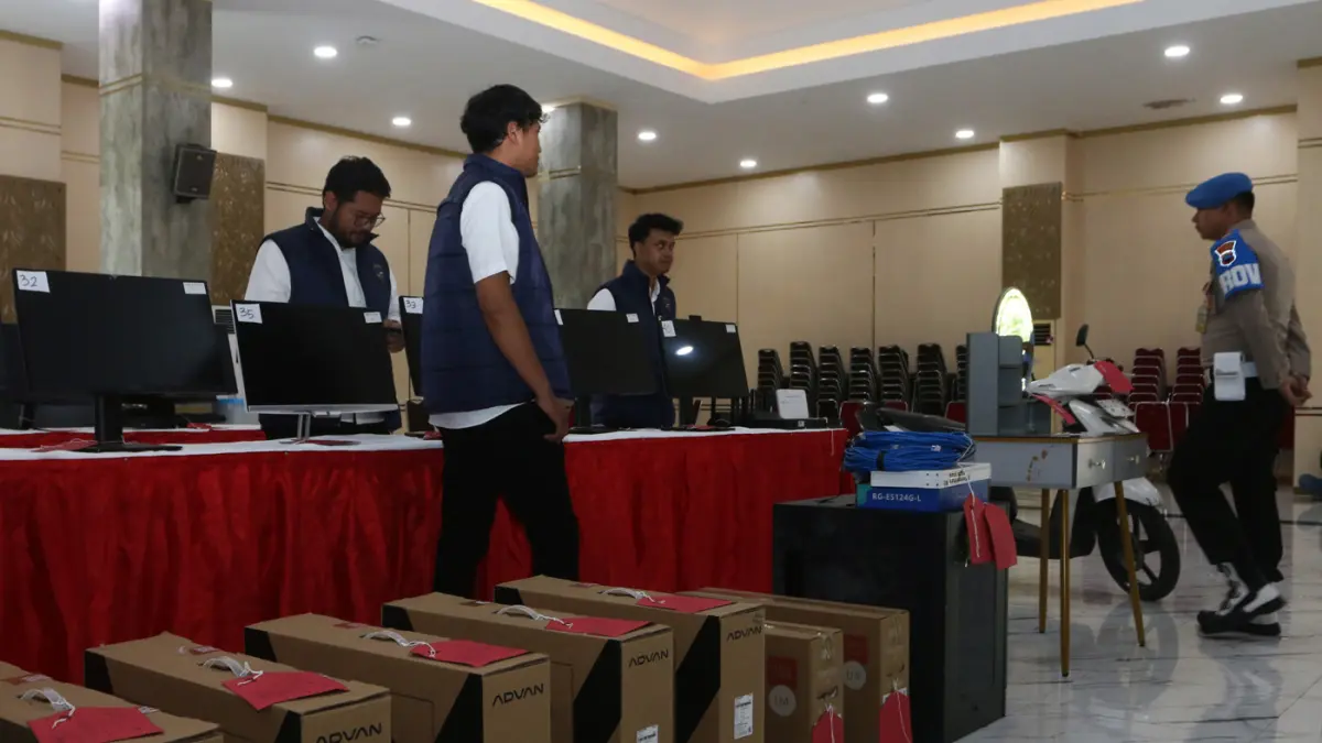 Penyidik berada di dekat barang bukti dalam rilis pengungkapan kasus dugaan penipuan daring dengan modus pig butchering di Polda Jawa Tengah, Semarang, Jawa Tengah, Senin (1/6/2026). (Nur Chamim/ Jawa Pos Radar Semarang)