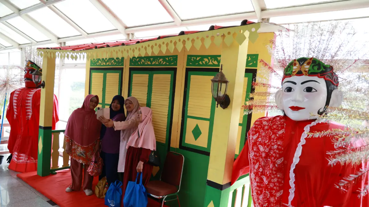 Warga Jakarta dihibur oleh kesenian Betawi Ondel-ondel saat memanfaatkan tarif spesial Rp. 1 LRT Jakarta yang berlaku pada perayaan HUT ke-499 Kota Jakarta di Stasiun Velodrome.