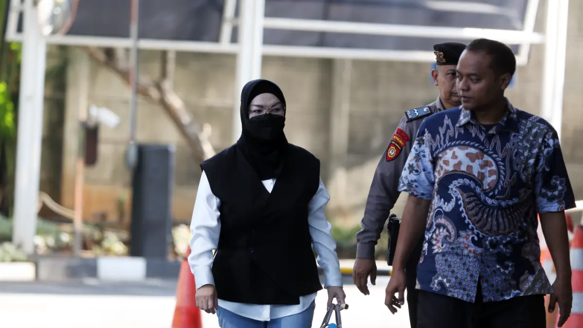 Bupati Sukoharjo Etik Suryani dikawal petugas saat tiba untuk menjalani pemeriksaan di Gedung Merah Putih KPK, Jakarta, Jumat (10/7/2026). (Dery Ridwansah/ JawaPos.com)