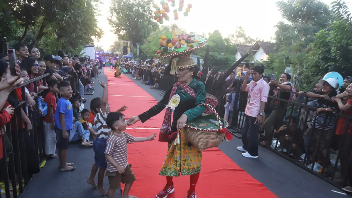 Ribuan warga memadati sepanjang jalan Desa Ngingasrembyong, Kecamatan Sooko, Kabupaten Mojokerto, menyaksikan Ngingas Mojo Carnival yang digelar untuk tahun kedua pada Minggu (12/7/2026). (Sofan/ Jawa Pos Radar Mojokerto)