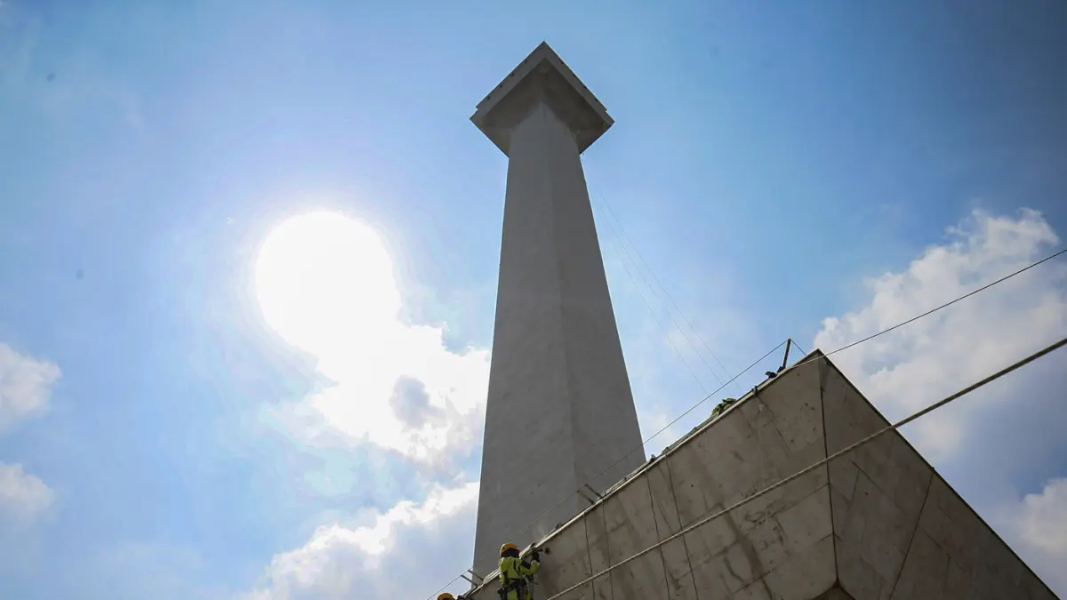 Petugas melakukan pembersihan badan tugu Monumen Nasional di Jakarta, Rabu (15/7/2026). (Salman Toyibi/Jawa Pos)