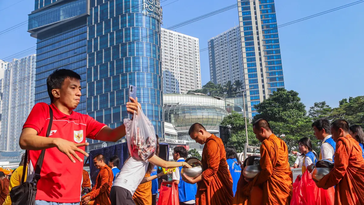 Rombongan Bhikkhu disambut umat Buddha di sepanjang Jalan Mayjen Jonosewojo, Surabaya, Minggu (19/7). (Riana Setiawan/ Jawa Pos)