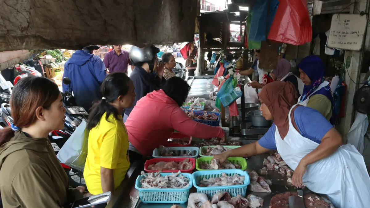 Pedagang ayam potong saat melayani pembeli di pasar Peterongan Kota Semarang,Jawa Tengah,Selasa(21/7/2026). (Nur Chamim/Jawa Pos Radar Semarang)