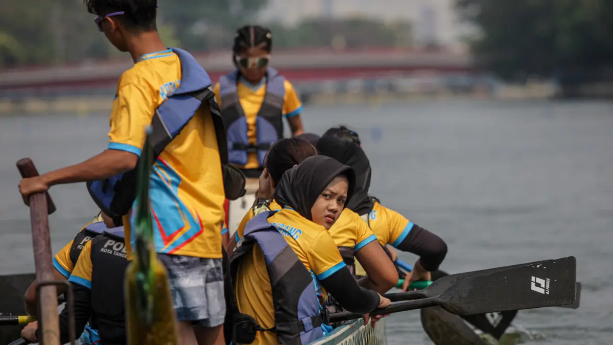 Sejumlah peserta berkompetisi dalam lomba dayung perahu naga di Sungai Cisadane, Kota Tangerang. (Hanung Hambara/Jawa Pos)