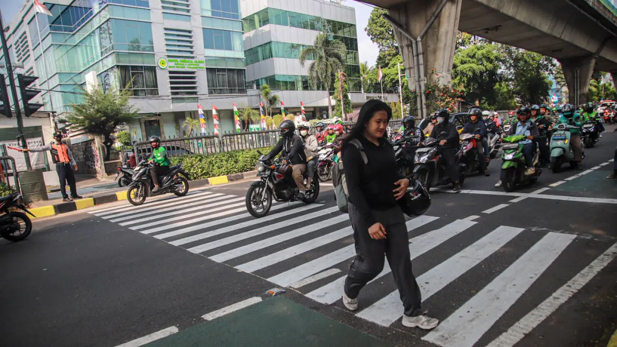 Sejumlah pejalan kaki melintas menggunakan fasilitas Pelican Crossing di Jalan Kapten Tendean, Jakarta, Selasa (04/08/2026). (Hanung Hambara/Jawa Pos)