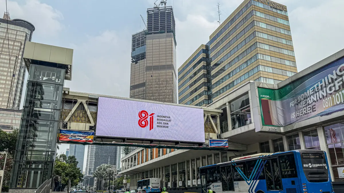 Sejumlah pengendara melintas di samping logo HUT RI ke-81 di Jalan M.H. Thamrin, Jakarta, Kamis (06/08/2026). (Hanung Hambara/Jawa Pos)