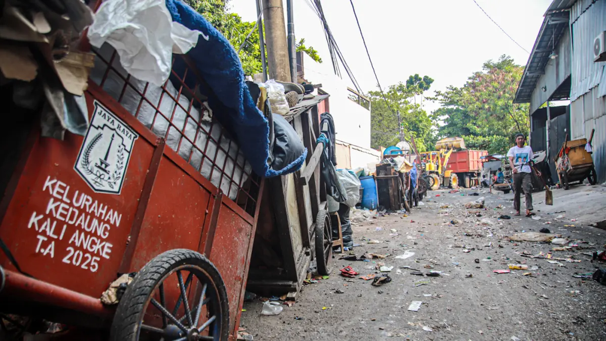 Sejumlah petugas dari PPSU dan Dinas LH Provinsi DKI Jakarta membersihkan tumpukan sampah yang menutup akses jalan di Kedaung Kali Angke, Cengkareng, Jakarta, Jumat (07/08/2026). (Hanung Hambara/Jawa Pos)