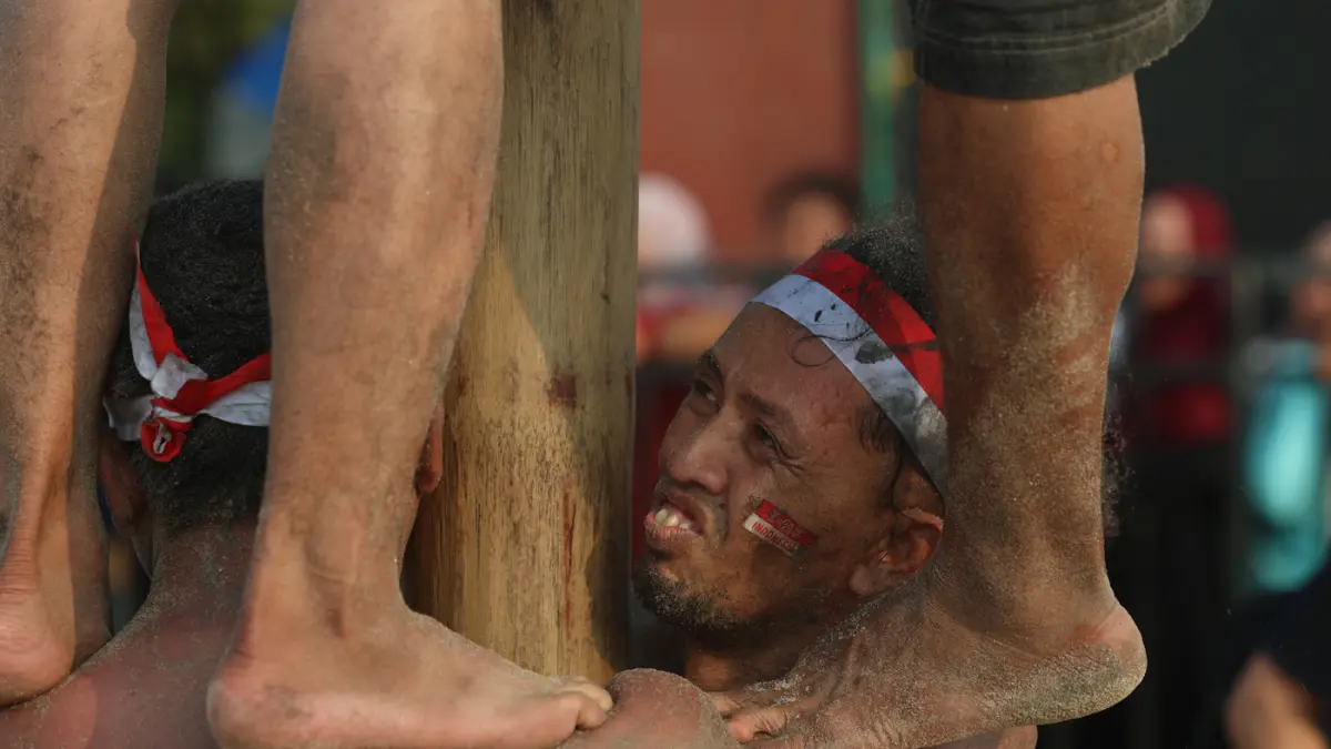 Peserta berusaha memanjat batang pinang saat mengikuti lomba memperingati Kemerdekaan Republik Indonesia di Beach Pool, Ancol, Jakarta, Senin (17/8/2026). (Dery Ridwansah/ JawaPos.com)
