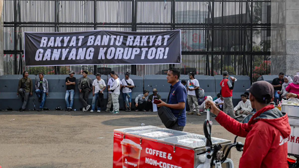 Spanduk bertuliskan Rakyat Bantu Rakyat Ganyak Koruptor terpasang di pagar depan Kompleks Parlemen, Senayan, Jakarta, Senin (24/8/2026). (Salman Toyibi/Jawa Pos)