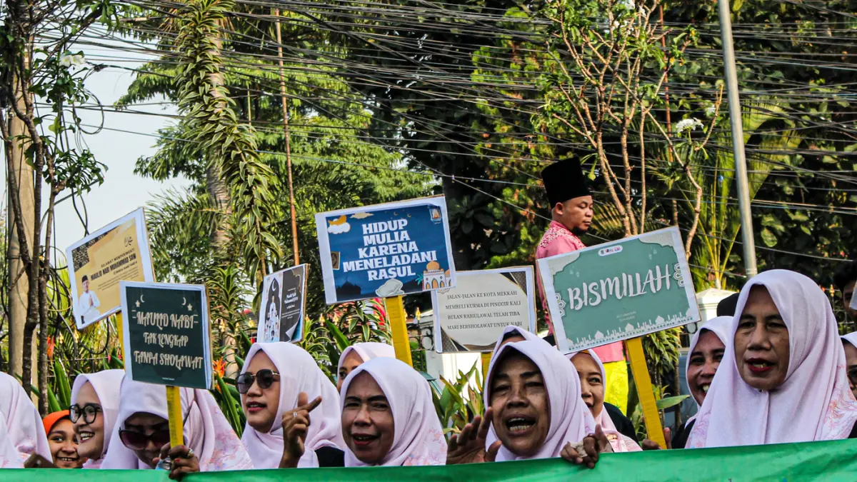 Warga mengarak beragam gunungan berisi hasil bumi dan makanan ringan di acara Ngarak Perahu Maulid depan masjid Al-Ittihad, Kota Tangerang, Selasa (25/08/2026). (Hanung Hambara/Jawa Pos)