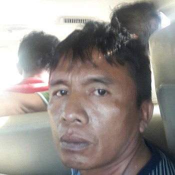 Iyus Pane (45), buron kasus perampokan di Pulomas Residence saat ditangkap aparat kepolisian - Image