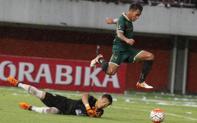 HARUS BERSIASAT: Striker PSS Sleman Rizki Novriansyah melewati hadangan kiper lawan. - Image
