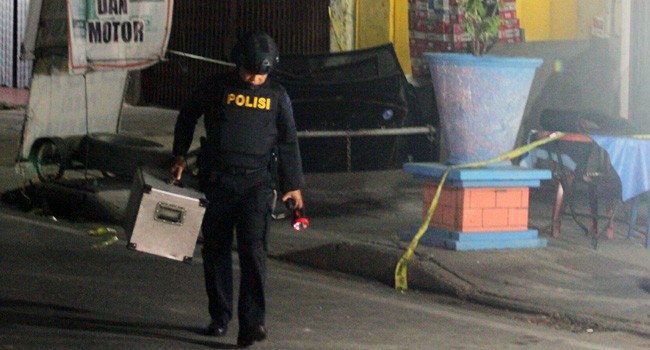 Tim Gegana Polda Riau mempersiapkan peralatan untuk menjinakkan barang yang diduga bom di salah satu toko Jalan Tuanku Tambusai, Pekanbaru. Minggu malam (11/12) - Image