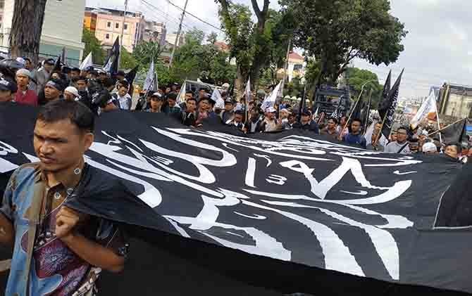 Massa mengarak dua bendera tauhid dalam aksi menuntut pembubaran Banser NU di Kota Medan, Kamis (25/10). - Image