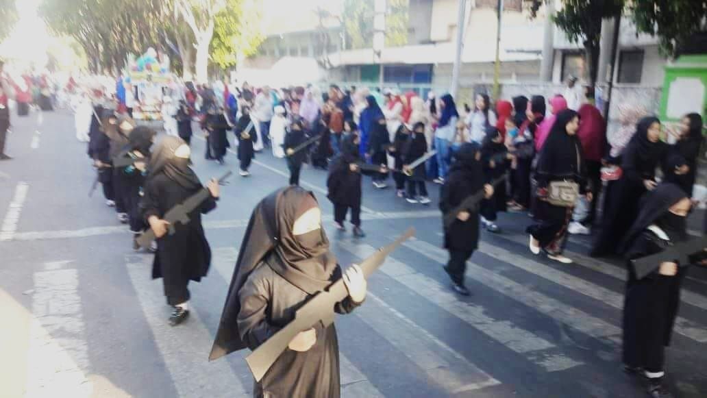 Peserta karnaval TK Kartika V 69 Kodim 0820 Probolinggo yang memakai cadar dan membawa senjata mainan - Image