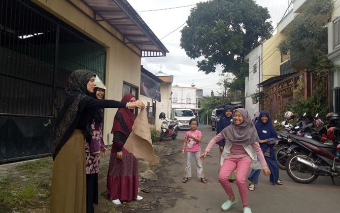 Salah seorang anak sedang mengikuti permainan tissue catcher dari Turki, Jumat (8/3). - Image