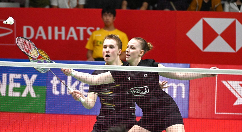 Delphine Delrue (R) and Thom Gicquel (L) of France hit a return to Wang Yilyu and Huang Dongping of China during their mix doubles semi-final match at the Indonesia Masters badminton tournament in Jakarta on January 18, 2020. (Photo by ADEK BERRY / AFP) - Image