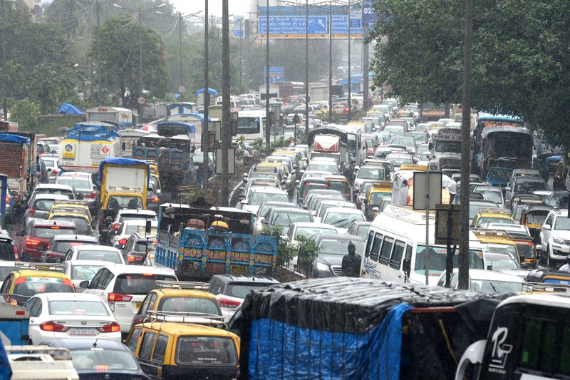 Heavy traffic is seen on a highway during heavy rain showers in Mumbai on September 4, 2019. (Photo by PUNIT PARANJPE / AFP) - Image