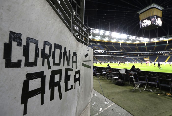FILE - In this Thursday, March 12, 2020 file photo shows a sign taped by Eintracht fans on a wall of the stadium during a Europa League round of 16, 1st leg soccer match between Eintracht Frankfurt and FC Basel in Frankfurt, Germany. All Champions League - Image