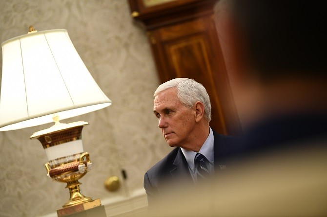 (FILES) In this file photo US Vice President Mike Pence listens as US President Donald Trump speaks during a meeting with Texas Governor Greg Abbott on May 7, 2020, in the Oval office of the White House in Washington, DC. - US Vice President Mike Pence is - Image