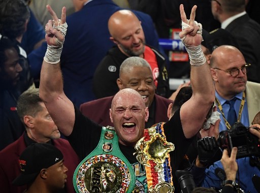 British boxer Tyson Fury celebrates after defeating US boxer Deontay Wilder in the seventh round during their World Boxing Council (WBC) Heavyweight Championship Title boxing match at the MGM Grand Garden Arena in Las Vegas on February 22, 2020. (Photo by - Image